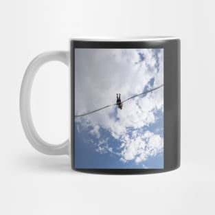 Girl in slingshot against blue cloudy sky Mug